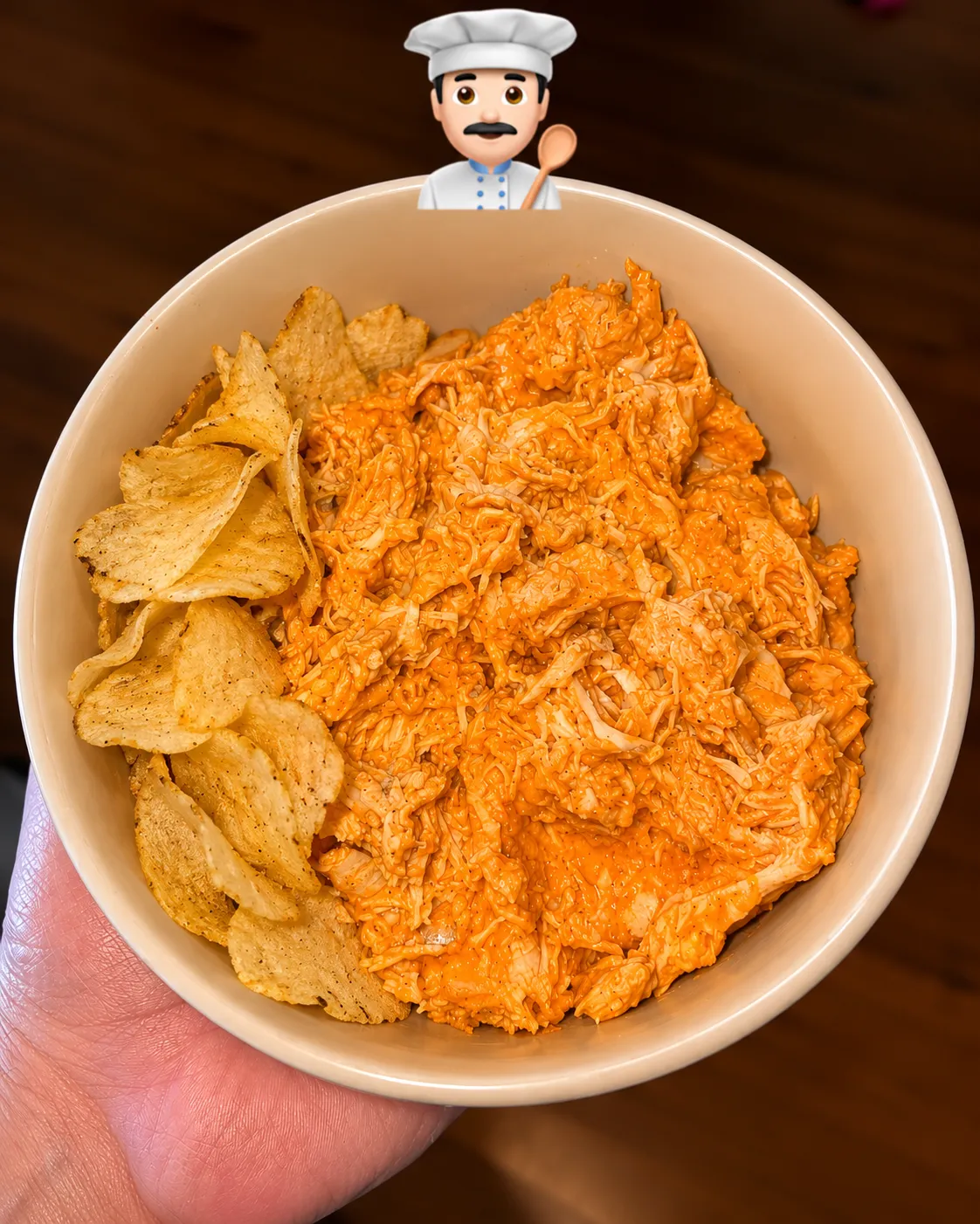 Shredded buffalo chicken in a bowl with potato chips