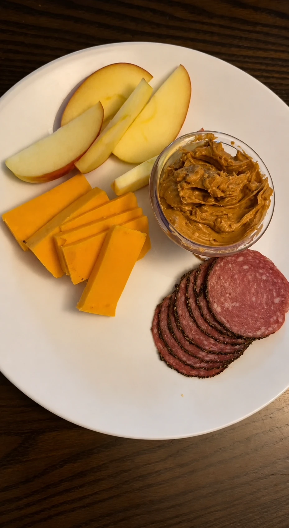 Easy no-cook snack plate with apple slices, cheddar, salami, and peanut butter