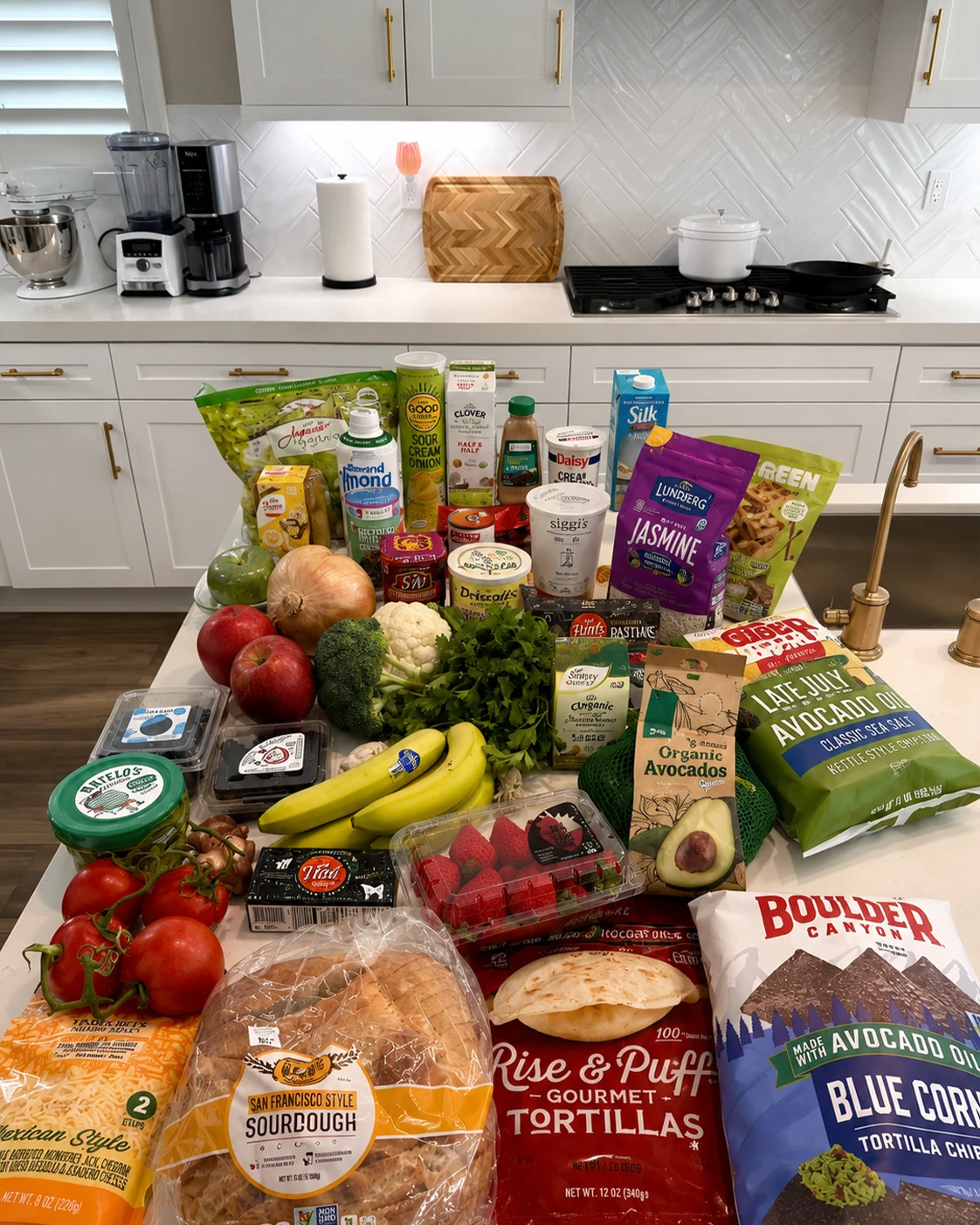 Budget grocery haul with fruit, vegetables, yogurt, rice, bread, and tortillas on the counter